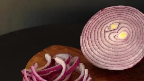 Rotation video of half of fresh sliced red onion on wooden table. Stock Footage 244488633