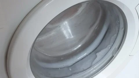 Rotation of washing machine drum while washing clothes. Stock Footage 279059345