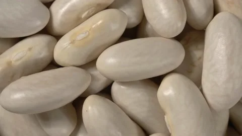 Rotation of white beans close up. Macro. 4K video. Organic legumes. Видео 143728932