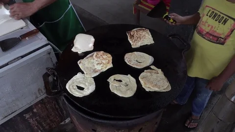 Roti Canai or Paratha maker at his stall. Stockbeeldmateriaal 77253243