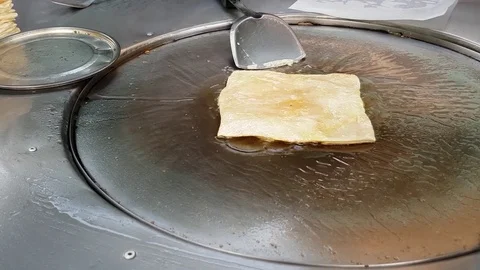 Roti. Fried bread sheet in iron pan. 4k. Stock Footage 75230889