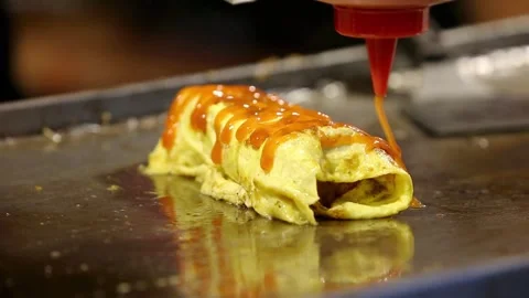 Roti John is being served with sauce, cheese and mayonnaise Stock Footage 265674990