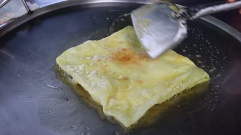 Roti making from flour and cheese in metal pan and hot oil Stock Footage 141305838
