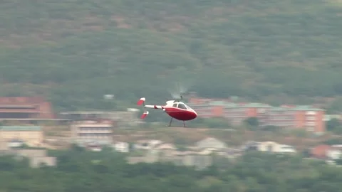 Rotorfly R-30 helicopter performs demonstration flight over waters of bay. Stock Footage 131583575