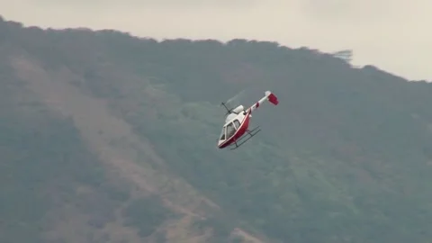 Rotorfly R-30 helicopter performs demonstration flight over waters of bay. Stock Footage 131583624