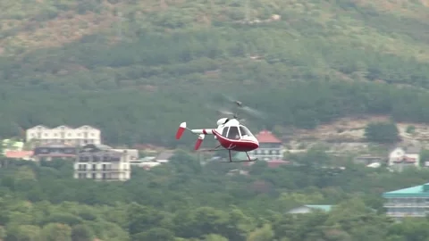 Rotorfly R-30 helicopter performs demonstration flight over waters of bay. Stock Footage 134032307