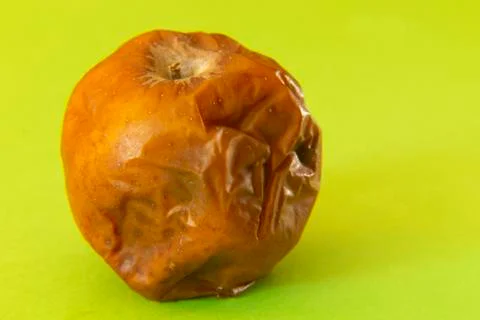 Rotten apple on a colored background Fotos de archivo