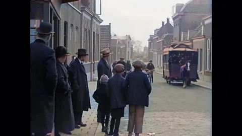 ROTTERDAM - 1925 - Children and commuters on sidewalk watch cyclists and horse Stock Footage 341973247
