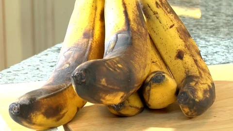 Rotting and brown bananas sit on countertop in kitchen Stock Footage 123732841