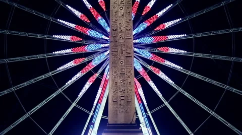 Roue de Paris behind the obelisk of Louxor at night in Paris Stock Footage 64130711