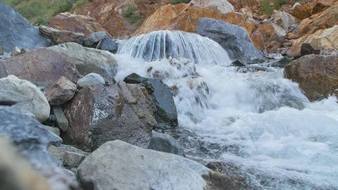 Rough and cold stream river flows down the rocks Stock Footage 146028556