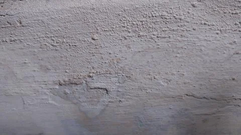 Rough and Worn Wall Texture. A photograph showcasing the distinctly rough a.. Stock Photos