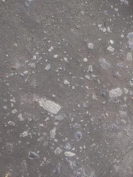 Rough asphalt texture with embedded stones background for weathered concrete Foto stock