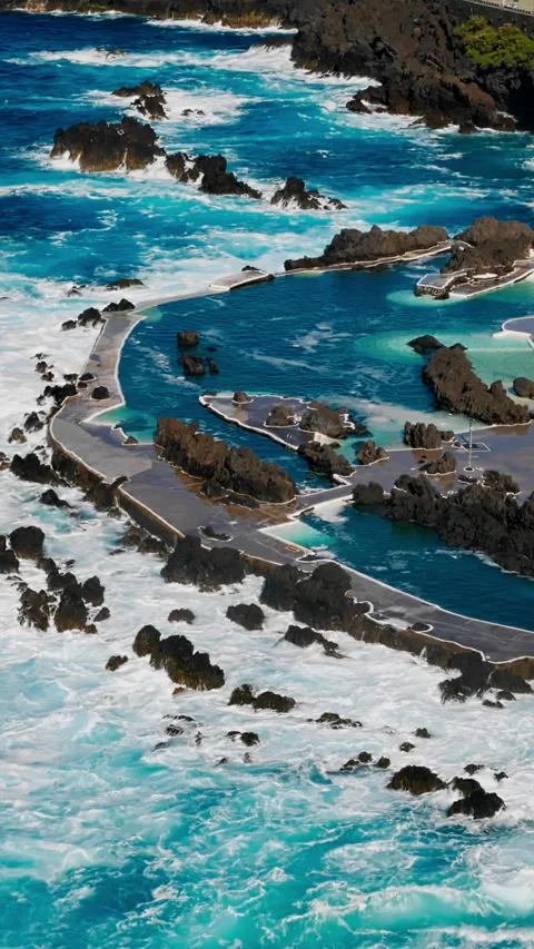 Rough Atlantic Ocean interacting with volcanic lava pools of Porto Moniz Stock Footage 340078676
