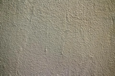 Rough beige stucco wall texture with detailed plaster surface Stock Photos