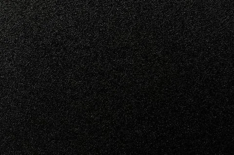 Rough black industrial plastic material surface Фото