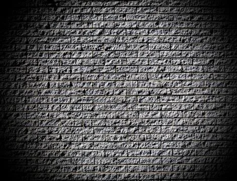 Rough brick wall with dark corners looking trough a hole Stock Photos