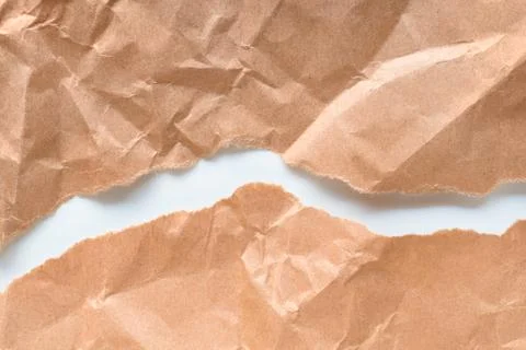 Rough brown paper torn by two parts Stock-Fotos