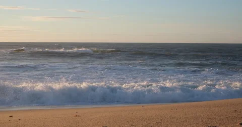 Rough choppy white waves breaking on sandy beach Stock Footage 146674038