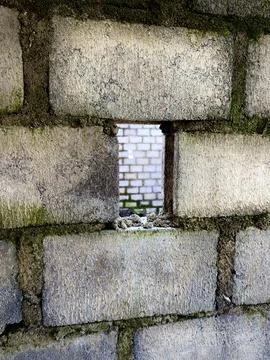 Rough concrete brick wall with vertical rectangular hole Stock Photos