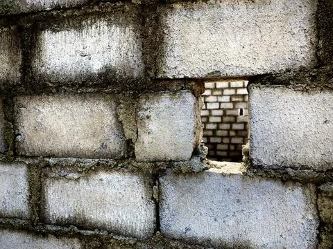 Rough concrete brick wall with vertical rectangular hole Stock Photos