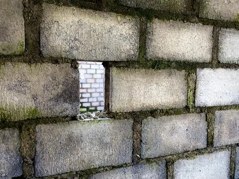 Rough concrete brick wall with vertical rectangular hole Stock Photos