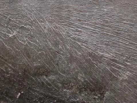 Rough concrete surface with deeply brushed diagonal grooves texture Foto stock