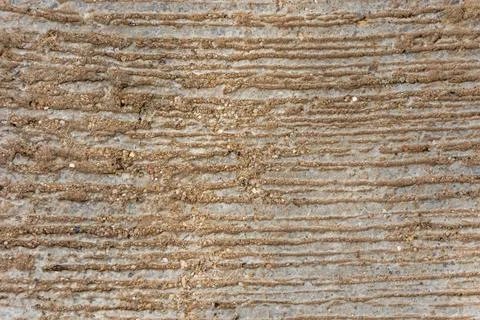 A rough concrete surface with linear grooves used to improve traction Stock Photos