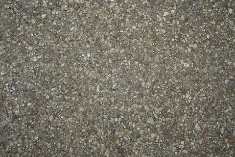Rough concrete texture with exposed small pebbles and aggregate stone surface Stock Photos