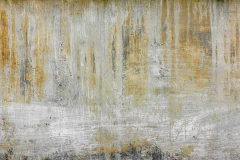 Rough concrete wall with old white paint strokes yellow streaks and stains Stockfoto's