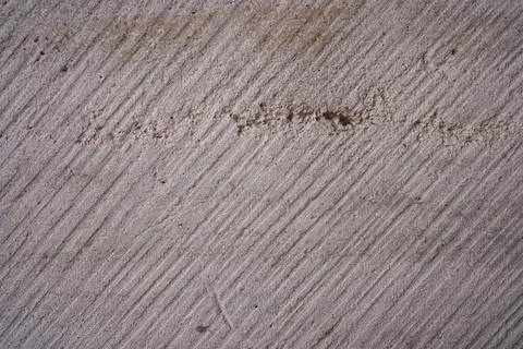Rough concrete wall texture with diagonal lines and natural stone background Stock Photos