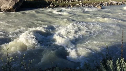 Rough current of a mountain cold river with rocks on rapids Video stock 94073560
