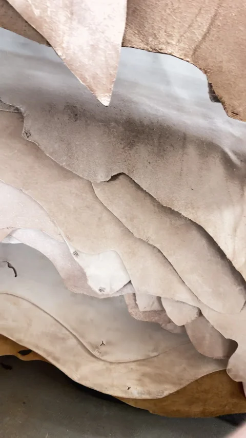 Rough cut leather sheets for crafting in warm, muted tones Stock-Footage 344907520