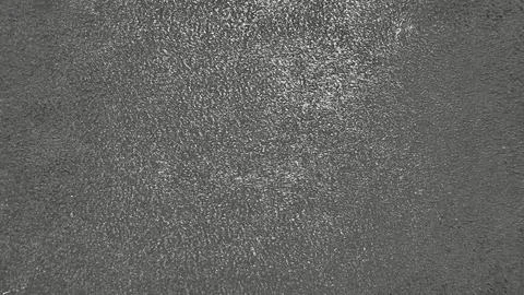 Rough dark gray asphalt texture macro view of granular pavement surface with  Foto stock