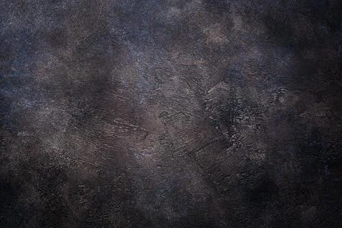 Rough dark texture of an old concrete wall in copper tones for a textured bac Stock Photos
