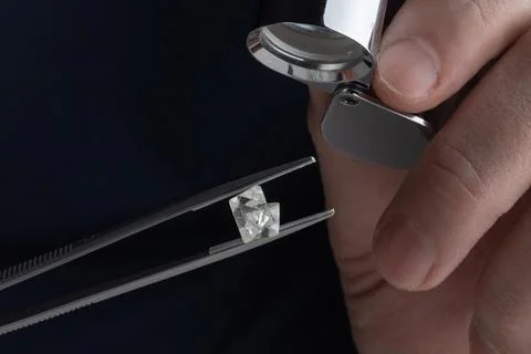 Rough diamond close up in the process of evaluation by diamond expert. Stock Photos