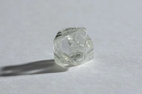 Rough diamond close up in the process of evaluation by diamond expert. Stock Photos