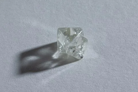 Rough diamond close up in the process of evaluation by diamond expert. Stock Photos