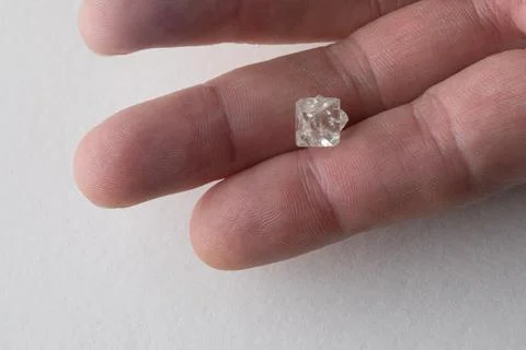 Rough diamond close up in the process of evaluation by diamond expert. Stock Photos