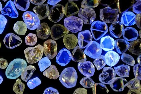 Rough diamonds under UV light Stock Photos