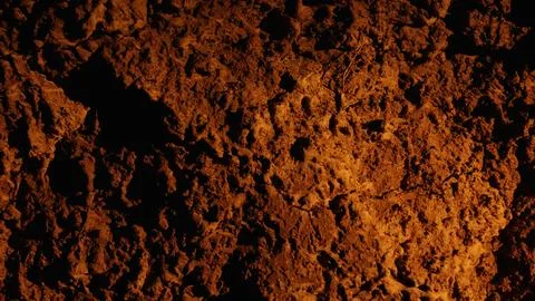 Rough earth surface creating abstract orange texture background Stock Photos