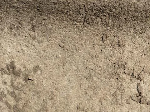 Rough earthen plaster wall texture with natural brown surface background Stock Photos