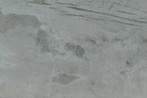 Rough flat wall plastered with concrete. Visible spots and stripes. Stock-Fotos