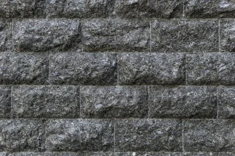 Rough granite Brick wall background. Background texture of stone wall. Stock Photos