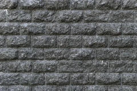 Rough granite Brick wall background. Background texture of stone wall. Stock Photos