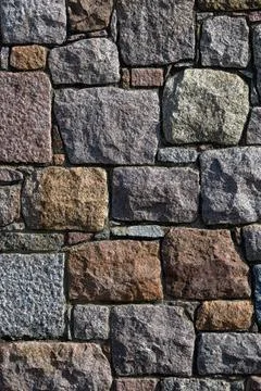Rough granite stone wall for use as a background texture Foto stock