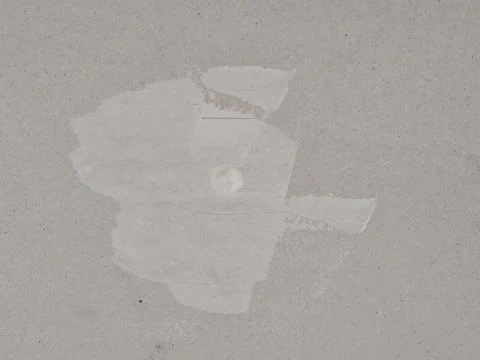 Rough Gray Beige Plaster Wall with Uneven White Paint Strokes Fotos Stock