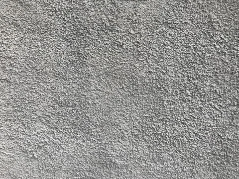 Rough gray concrete wall texture in natural daylight Stock Photos