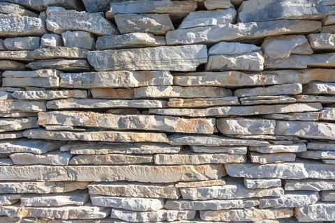 Rough Gray Stone Wall With Irregular Rocks For Rustic Masonry And Exterior Stock Photos