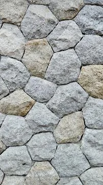 ​Rough gray stone wall texture background, natural masonry rock pattern. Stock Photos